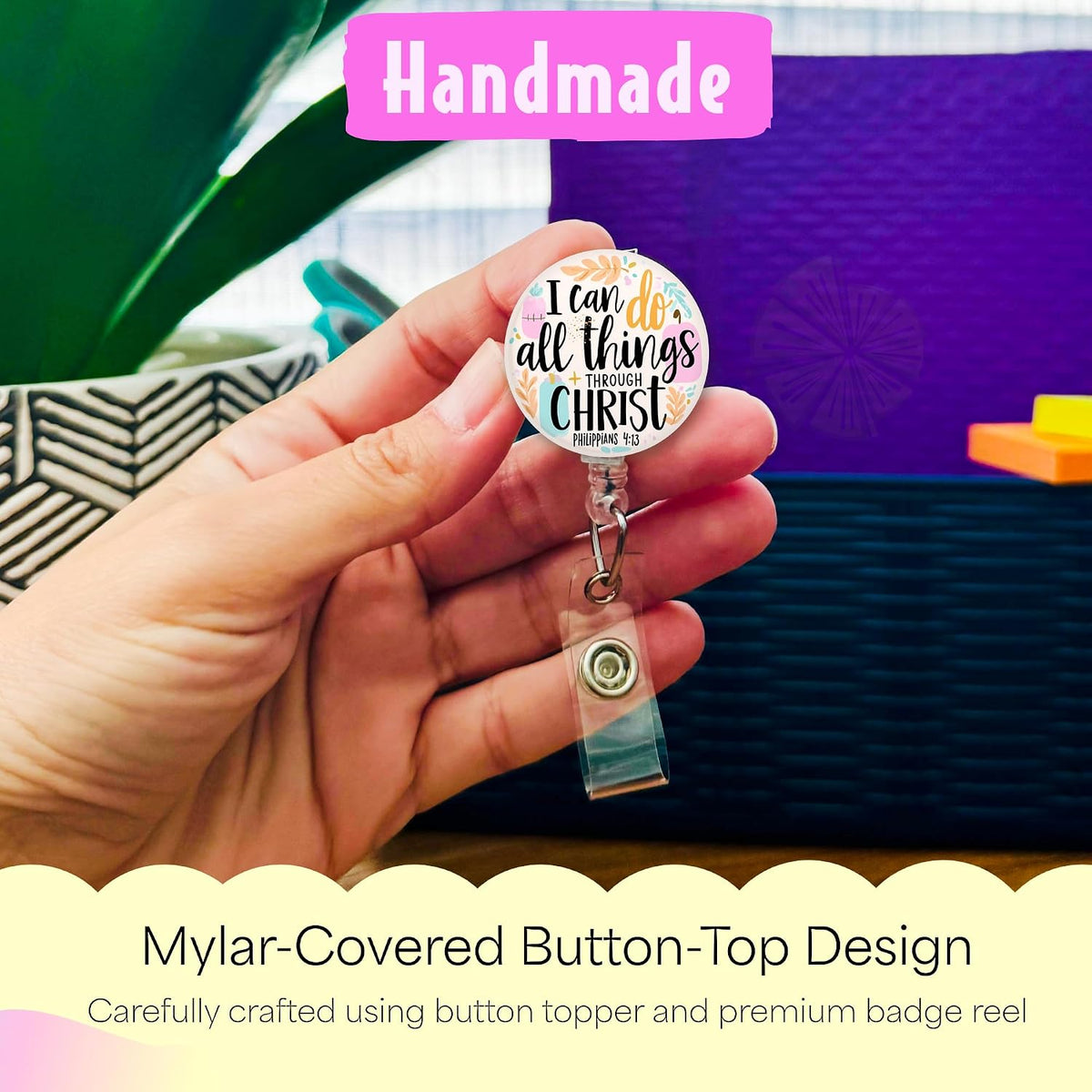Hand holding the I Can Do All Things handmade badge reel