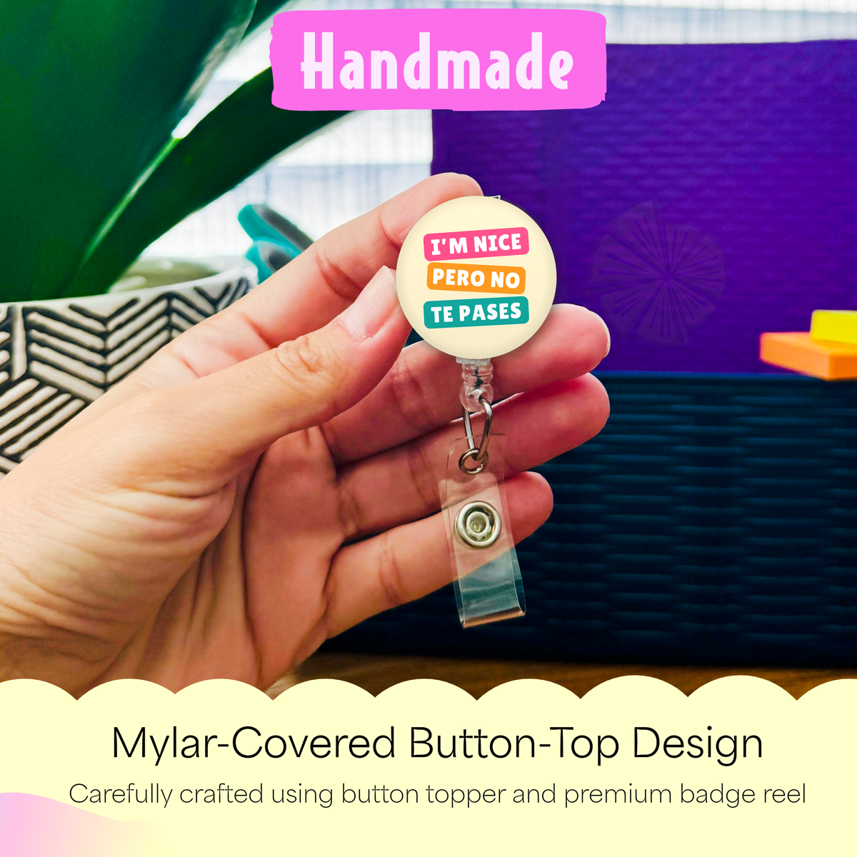 Hand holding the I'm Nice Pero No Te Pases handmade badge reel