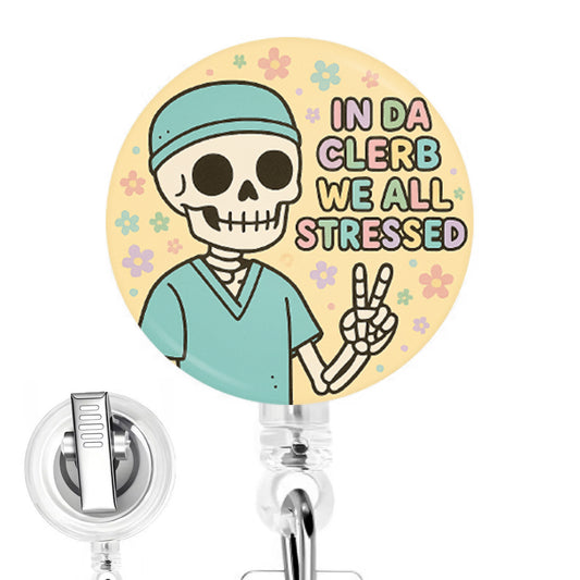In Da Clerb We All Stressed handmade button-top badge reel on a clear retractable reel