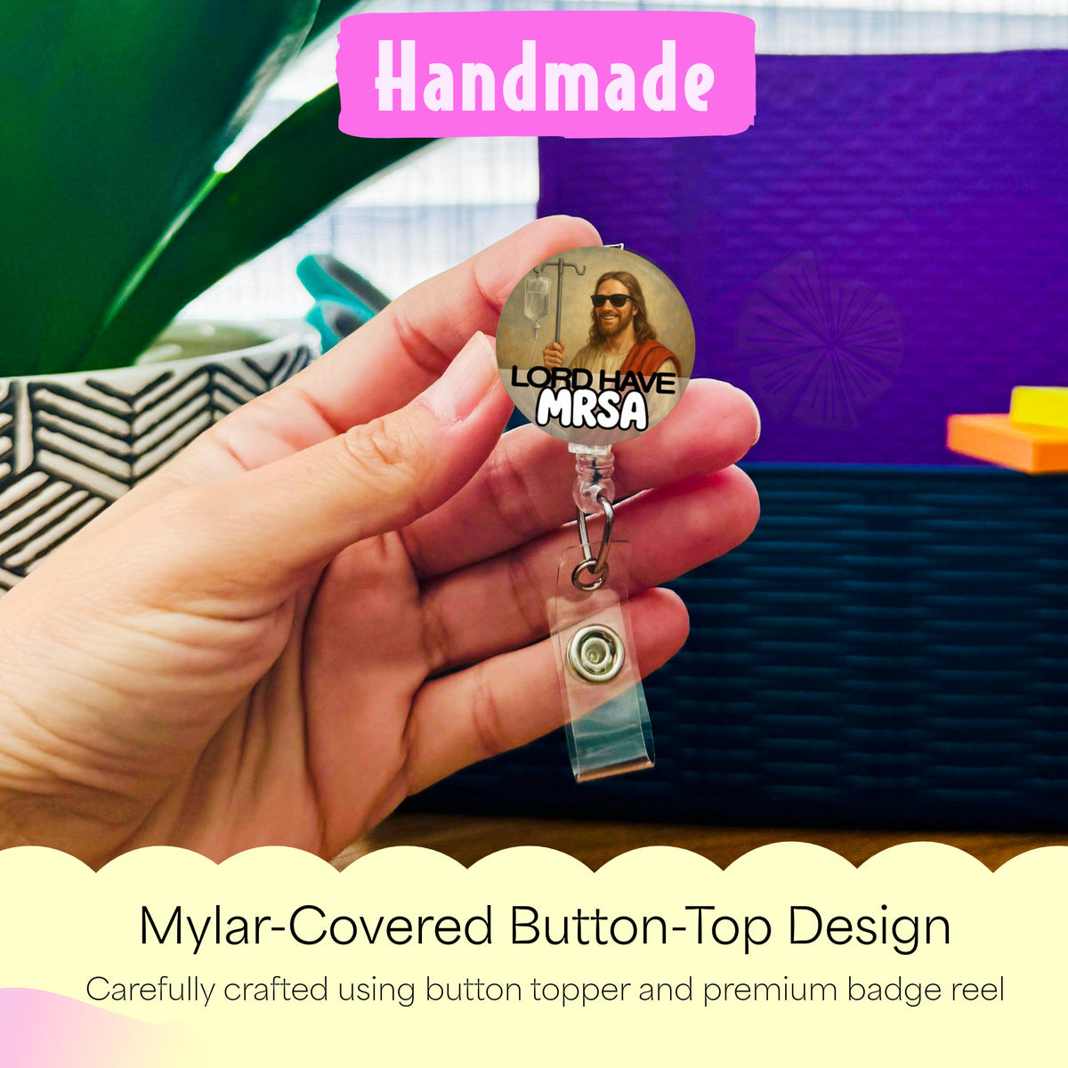 Hand holding the Lord Have MRSA handmade badge reel